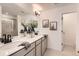 Modern bathroom with double vanity, large mirror, decorative vases, stylish light fixture, and framed art pieces at 374 North Geneva, Aurora, CO 80010