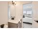 Bright bathroom with a modern vanity and a glimpse into a bedroom, showcasing a clean and contemporary design at 374 North Geneva, Aurora, CO 80010