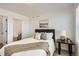 Inviting bedroom featuring a comfortable bed, a rustic side table, and an ensuite bathroom for added privacy and convenience at 374 North Geneva, Aurora, CO 80010