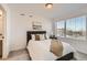 Cozy bedroom with a large window offering a neighborhood view, complemented by neutral tones and comfortable furnishings at 374 North Geneva, Aurora, CO 80010
