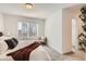 Bright bedroom with a large window, plush carpeting, and a comfortable chair near the entrance to the walk-in closet at 374 North Geneva, Aurora, CO 80010