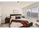 Well-lit bedroom featuring a comfortable bed with a striped blanket and decorative pillows, flanked by nightstands at 374 North Geneva, Aurora, CO 80010