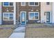 Townhome's front entrance with a bright blue door, a concrete path, and fresh landscaping at 374 North Geneva, Aurora, CO 80010