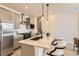 Stylish kitchen featuring gray cabinets, stainless steel appliances, and a granite island at 374 North Geneva, Aurora, CO 80010