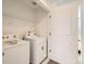 Convenient laundry room featuring a washer, dryer, wire rack shelving, and a door leading to another area of the home at 374 North Geneva, Aurora, CO 80010