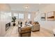 Bright living room with a modern fireplace, neutral furniture, and large windows at 374 North Geneva, Aurora, CO 80010