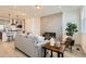 Open-concept living space flows to the kitchen, featuring a sleek fireplace at 374 North Geneva, Aurora, CO 80010