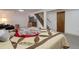 Spacious basement featuring a cozy seating area, stairs, and carpeted floors at 8221 Ralph Ln, Denver, CO 80221