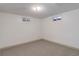 Empty room with neutral carpet, two small windows providing natural light at 8221 Ralph Ln, Denver, CO 80221