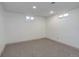 Finished basement features two windows for ample natural light, and neutral carpet at 8221 Ralph Ln, Denver, CO 80221