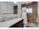 Updated bathroom featuring marble countertops, marble tiled shower and modern fixtures at 8221 Ralph Ln, Denver, CO 80221