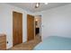 Bedroom features two wooden doors, plush carpeting, and a glimpse into the ensuite bathroom at 8221 Ralph Ln, Denver, CO 80221