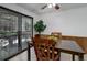 Eat-in kitchen with wooden cabinetry, a tile floor, and a glass sliding door leading to the outside area at 8221 Ralph Ln, Denver, CO 80221