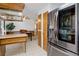 Traditional eat-in kitchen featuring stainless steel appliances, wooden cabinetry, and tile floors at 8221 Ralph Ln, Denver, CO 80221