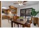 Eat-in kitchen with wooden cabinetry, a tile floor, and a glass sliding door leading to the outside area at 8221 Ralph Ln, Denver, CO 80221