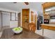 Eat-in kitchen with wooden cabinetry, stainless steel appliances, and view of another room at 8221 Ralph Ln, Denver, CO 80221