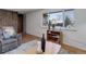 Inviting living room with hardwood floors, a comfortable recliner, and a large window for plenty of natural light at 8221 Ralph Ln, Denver, CO 80221