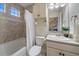 Bright bathroom with a shower and tub combo, plus a single sink vanity at 315 Painted Horse Way, Erie, CO 80516