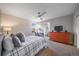 Cozy bedroom with a ceiling fan, a window and an ensuite bathroom at 315 Painted Horse Way, Erie, CO 80516