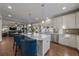Modern kitchen with granite countertops, stainless steel appliances, large windows for ample natural light, and seating at the island at 315 Painted Horse Way, Erie, CO 80516