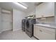 Spacious laundry room with modern washer and dryer, plus storage cabinets at 315 Painted Horse Way, Erie, CO 80516