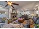 Open living room features a fireplace, hardwood flooring, coffered ceiling, and access to the kitchen for easy entertaining at 315 Painted Horse Way, Erie, CO 80516