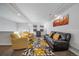Bright living room featuring a leather sofa, armchairs, and a modern rug at 315 Painted Horse Way, Erie, CO 80516