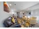 Bright living room featuring a leather sofa, armchairs, and a modern rug at 315 Painted Horse Way, Erie, CO 80516