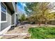 Backyard with patio, seating, fire pit, lawn, and landscaping at 18572 E Tanforan Pl, Aurora, CO 80015
