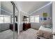 Well-lit bedroom with a dresser, plush carpet, and ambient LED strip lighting at 18572 E Tanforan Pl, Aurora, CO 80015