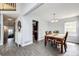 Comfortable dining room featuring hardwood-style floors and a view into the living room at 18572 E Tanforan Pl, Aurora, CO 80015
