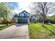 Charming two-story home featuring a well-manicured lawn, a two-car garage, and tasteful landscaping at 18572 E Tanforan Pl, Aurora, CO 80015