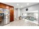 Modern kitchen featuring stainless steel appliances, wood cabinets, and a view to the living room at 18572 E Tanforan Pl, Aurora, CO 80015