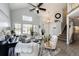 Bright living room with high ceilings, an open layout and hardwood-style floors at 18572 E Tanforan Pl, Aurora, CO 80015