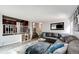 Inviting living room featuring a large sectional sofa and an open view of the kitchen at 18572 E Tanforan Pl, Aurora, CO 80015
