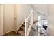 Carpeted staircase leading to a bright, open living area with vaulted ceilings at 18572 E Tanforan Pl, Aurora, CO 80015