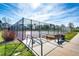 Community tennis court surrounded by a black chain link fence and ample seating at 18572 E Tanforan Pl, Aurora, CO 80015