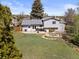 A well-maintained backyard featuring a lush lawn, patio area, and mature trees, ideal for outdoor entertaining and relaxation at 17900 E Mexico Dr, Aurora, CO 80017