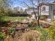 Landscaped backyard featuring a decorative pond with bridge, table set and spacious lawn area at 17900 E Mexico Dr, Aurora, CO 80017