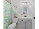 Bathroom featuring a vanity with drawers, a mirror, and a toilet with a unique cactus shower curtain at 17900 E Mexico Dr, Aurora, CO 80017