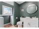 Cozy bathroom featuring a single sink vanity with ample storage space and a separate toilet area at 17900 E Mexico Dr, Aurora, CO 80017