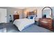 Bedroom featuring a blue color scheme, ample drawer space, and forest wall art at 17900 E Mexico Dr, Aurora, CO 80017