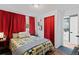 Comfortable bedroom with a queen-sized bed, soft lighting, and red curtains to create a cozy atmosphere at 17900 E Mexico Dr, Aurora, CO 80017