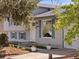 Inviting home facade, with a tidy lawn, concrete walkway, and a covered front entry and attached garage at 17900 E Mexico Dr, Aurora, CO 80017