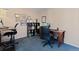 Home office space featuring a large desk, rolling chair, shelving, and a neutral color palette at 17900 E Mexico Dr, Aurora, CO 80017