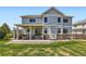 Spacious backyard with an outdoor patio and grill, surrounded by lush green grass at 22197 E Stroll Ave, Parker, CO 80138