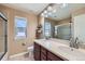 Bathroom featuring double sinks, a shower, and a large mirror at 22197 E Stroll Ave, Parker, CO 80138