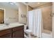 Cozy bathroom with a shower-tub, and vanity with dark cabinets and neutral colored finishes at 22197 E Stroll Ave, Parker, CO 80138