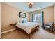 Comfortable bedroom featuring a wooden bed frame, blue accents, and soft natural lighting at 22197 E Stroll Ave, Parker, CO 80138