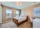 Bedroom with a large window, a desk, and neutral decor at 22197 E Stroll Ave, Parker, CO 80138